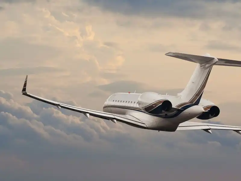 Small passenger jet flying and surrounded by clouds