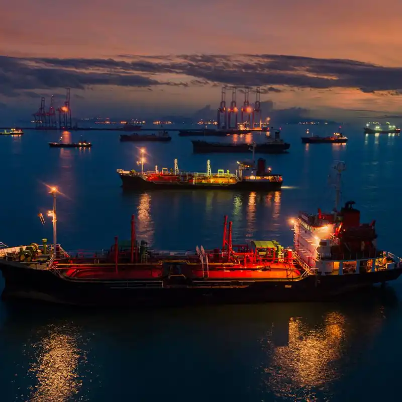 Aerial view of ship tanker park on the sea waiting for load or unload oil from refinery.