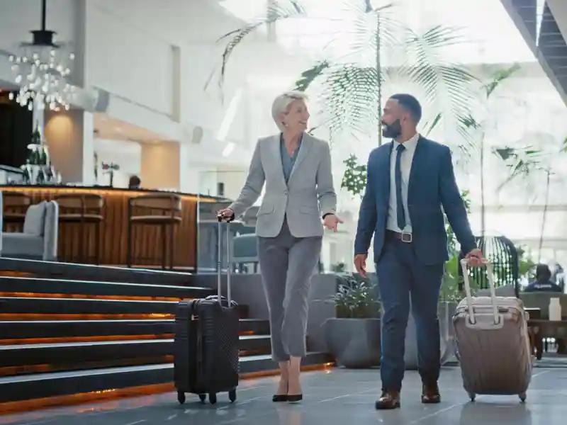 Business Employees Walking Through Airport.