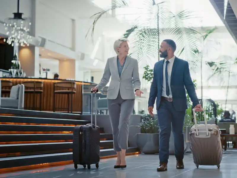 Business Employees Walking Through Airport.