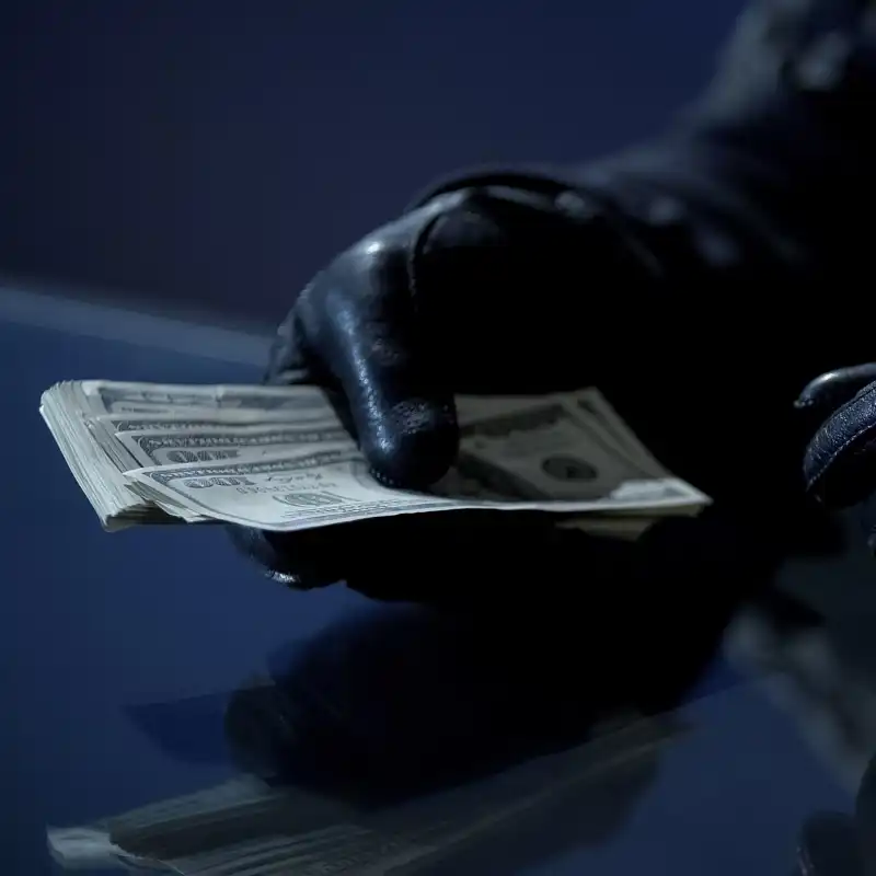 Criminal counting ransom money for kidnapping or blackmail.
