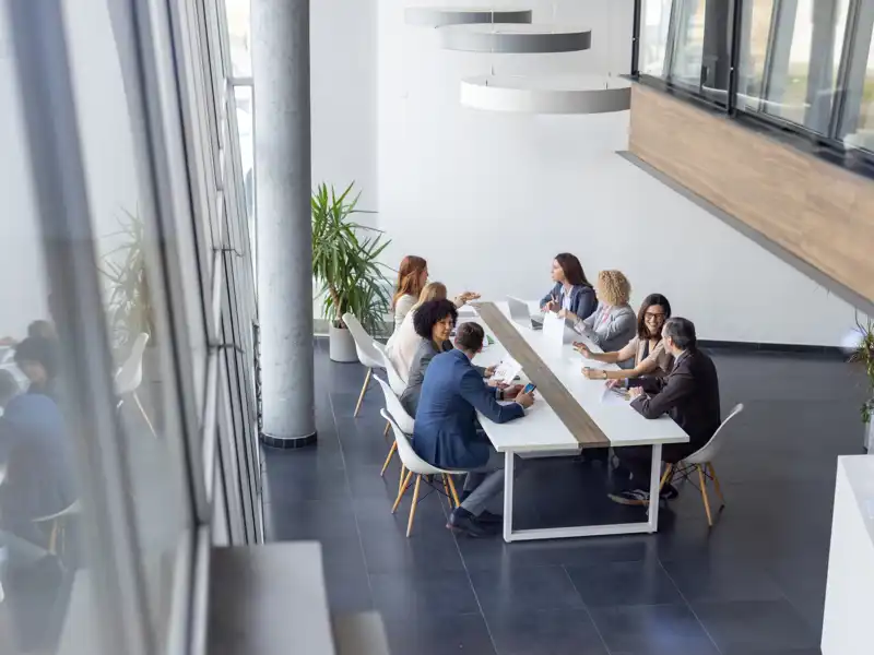 Coworkers in a meeting inside modern office.
