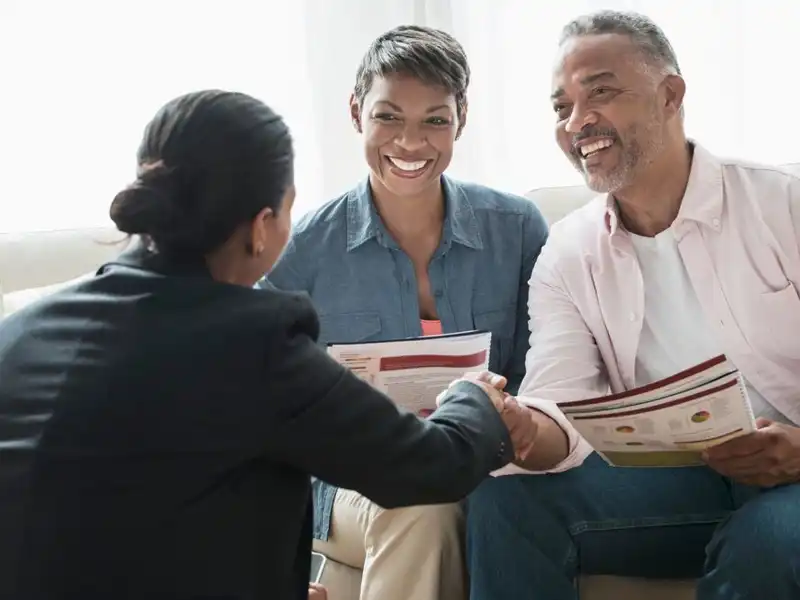 African American couple talking to financial advisor.