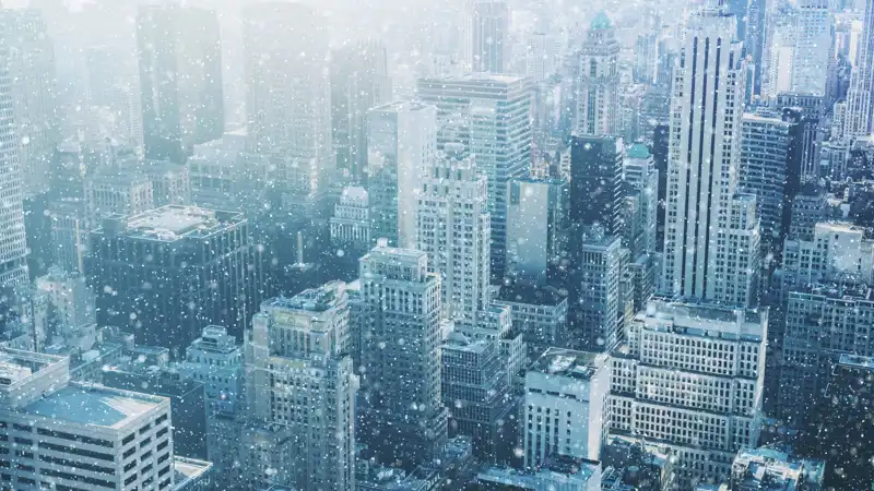 Snow falling in New York City.