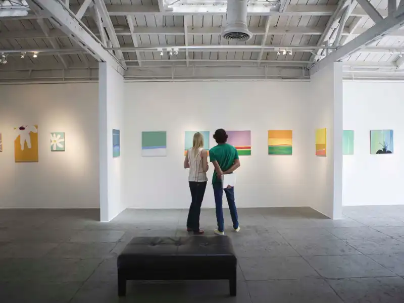 a young couple looking at art during an exhibit