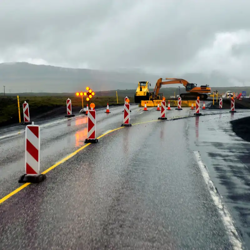 Highway construction on a rainy, cloudy day.