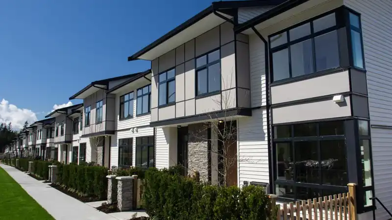 Residential townhouses on blue sky background on sunny day.