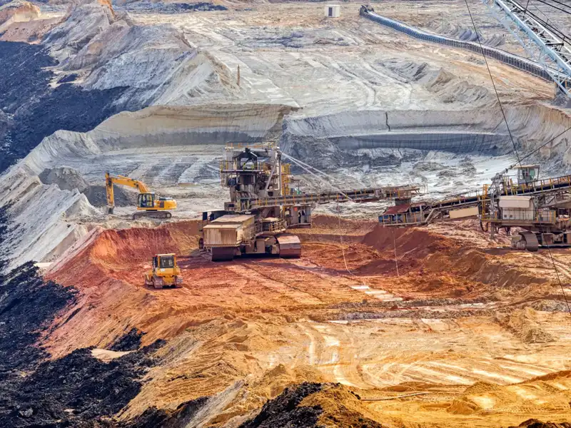 Open mining pit with heavy machinery