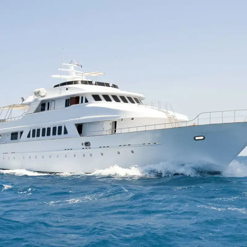 A large private motor yacht under way out at sea.