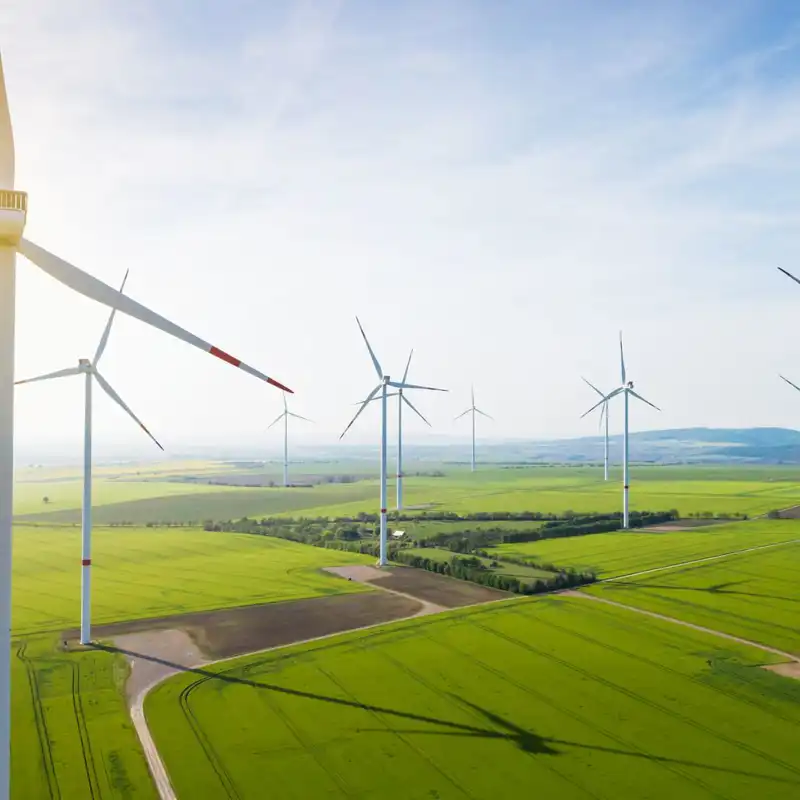 Aerial view of wind turbines and agriculture field.