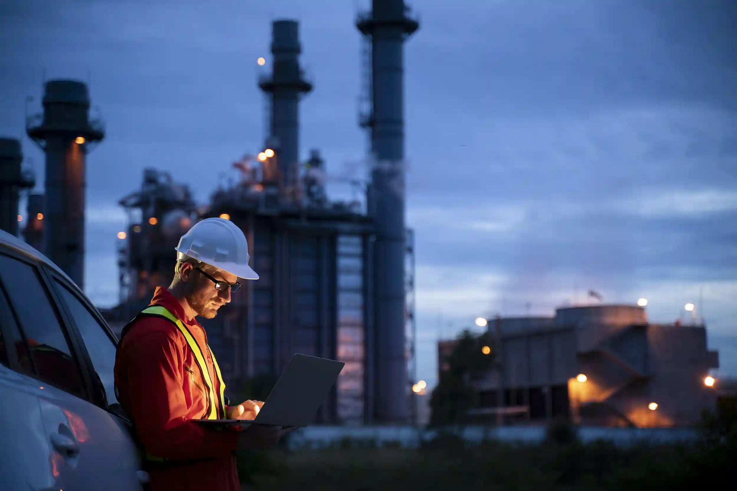 construction worker looking at laptop in the early morning