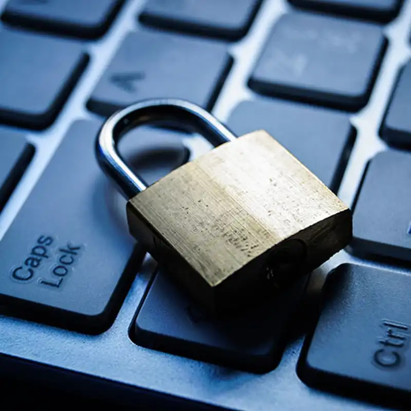 A small padlock sits atop a computer keyboard.