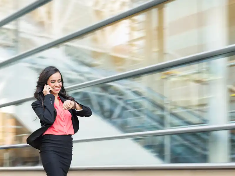 Business woman walking while talking on a phone.