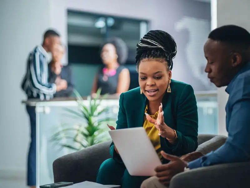 Human resources professional helping a coworker with paperwork