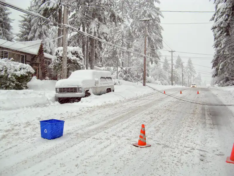 downed electrical wire across a snowy street