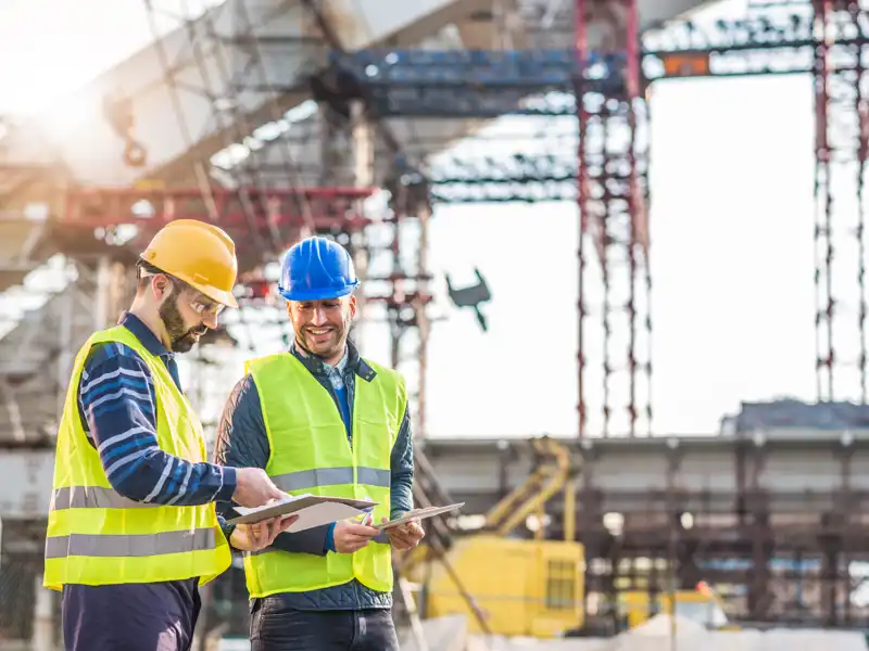 Two construction workers looking at plans.