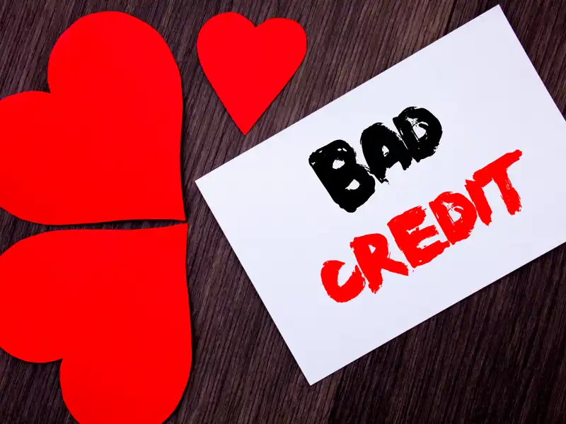 Graphic of hearts next to a sign that reads bad credit.
