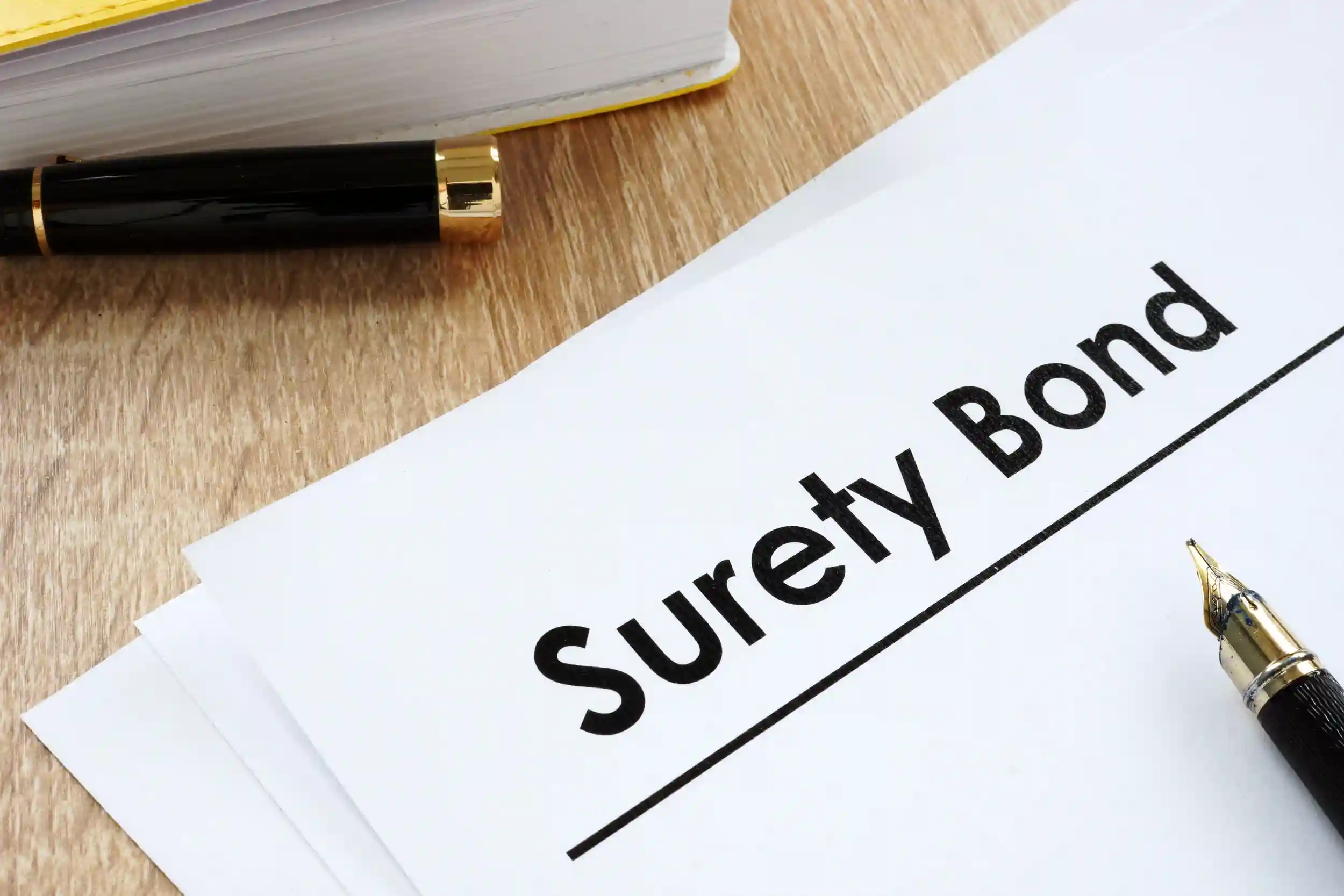 Image of a surety bond and a black pen.