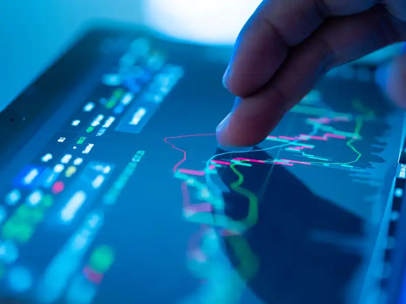 Close up of a finger on a tablet touching a graph.