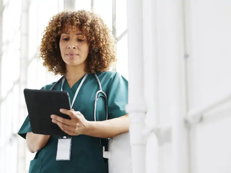 A nurse using a tablet device