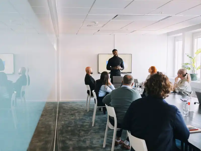 Man leading a business meeting in a modern office