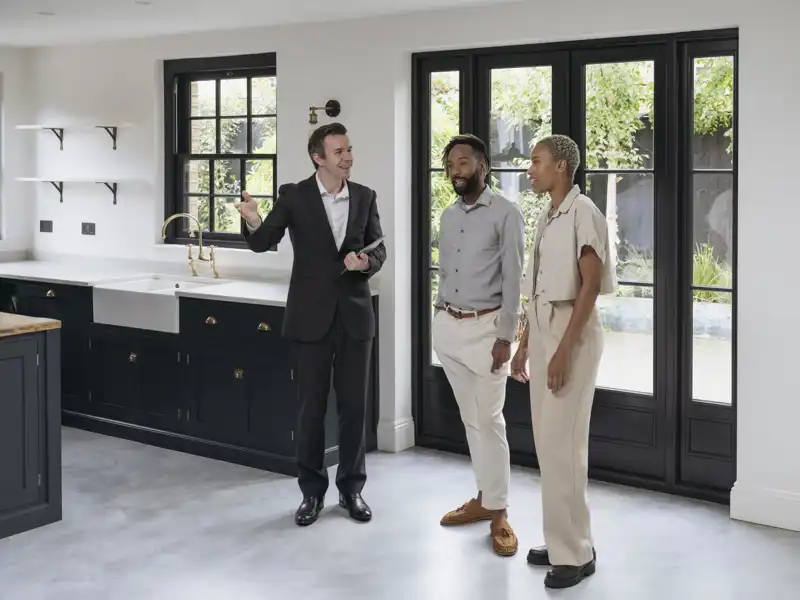 realtor showing clients a house
