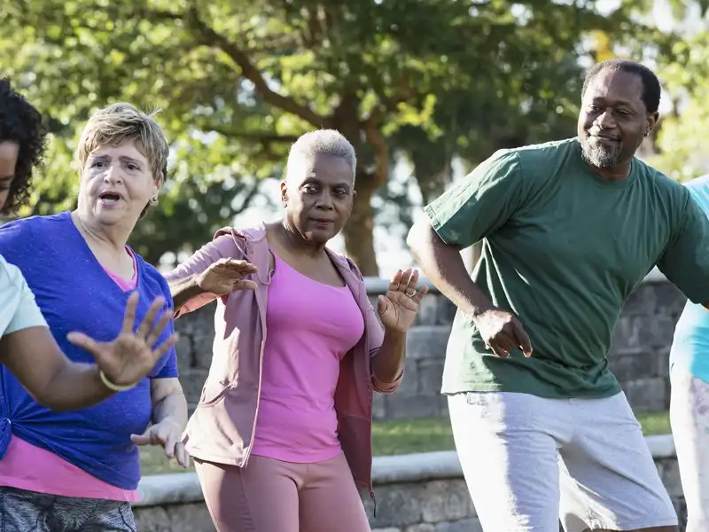 A group of retirees exercising in a park