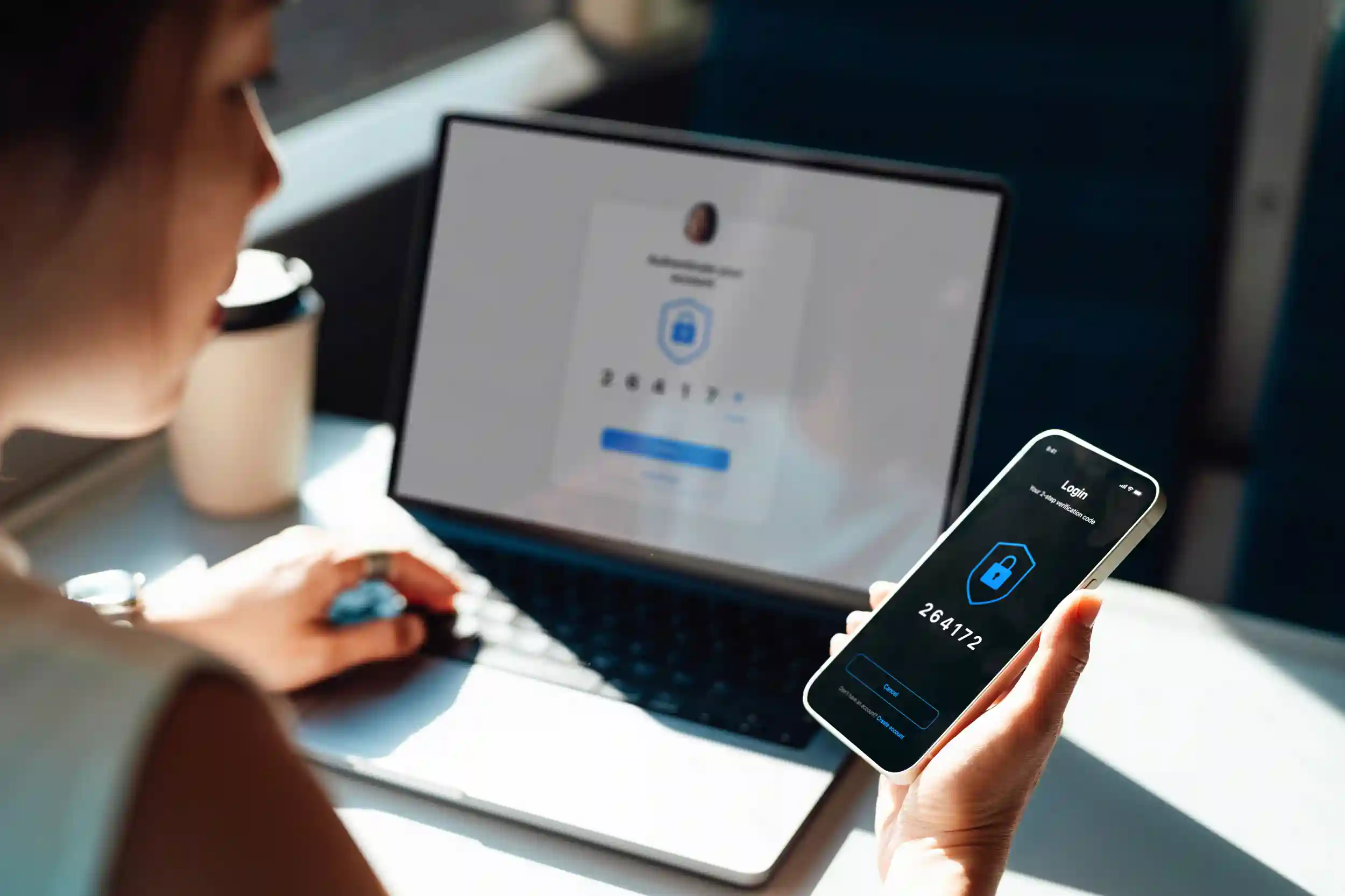 A woman looking at a two-factor authenticator code on her phone
