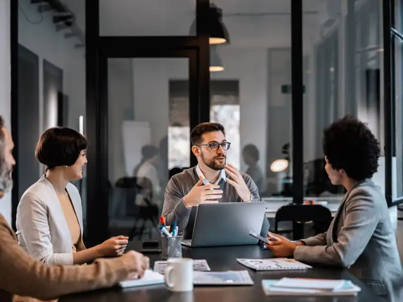 A group of coworkers sitting around an office table.