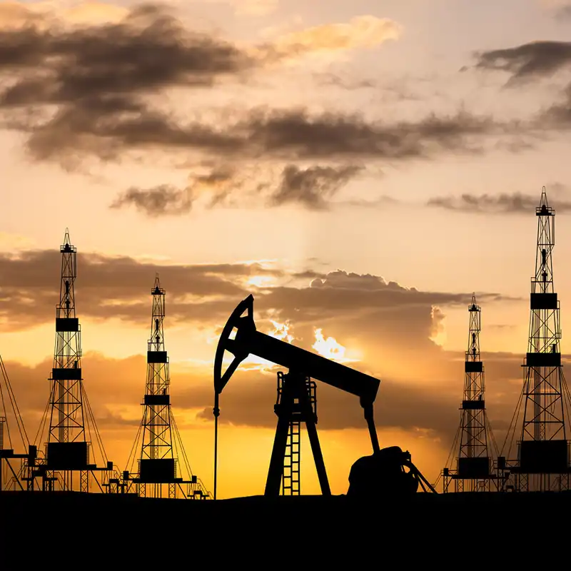 Oil rigs pumping on at sunrise.