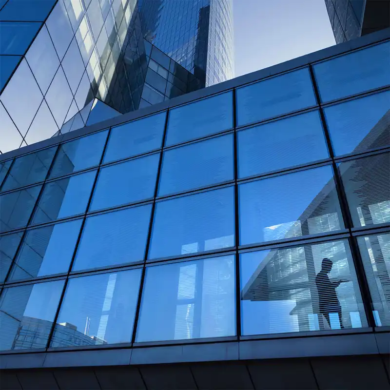 Close up of an office building with large windows.