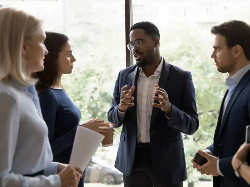 Four people standing and talking