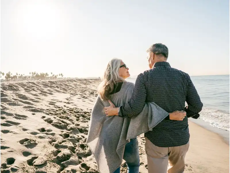 Senior couple walking on the beach