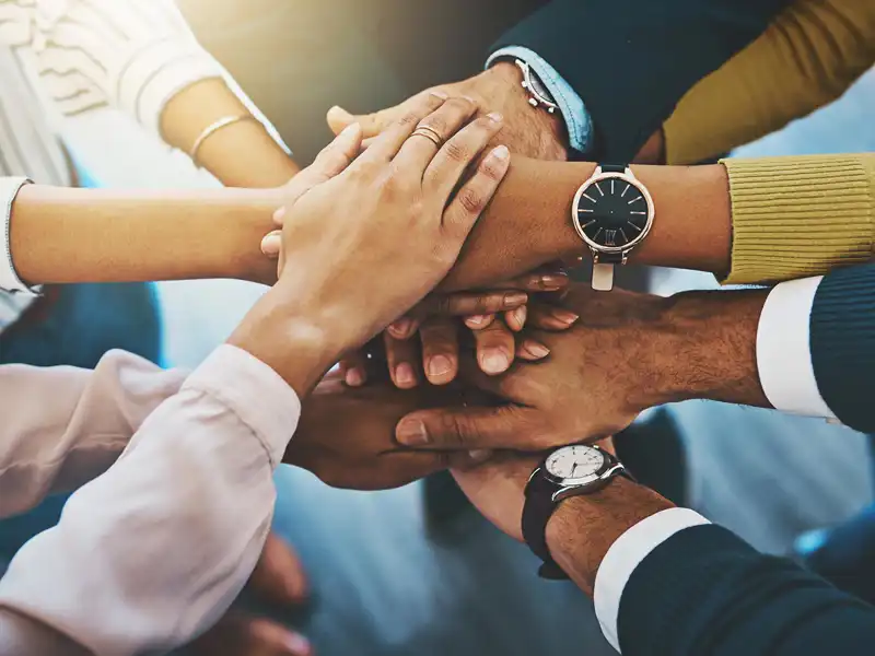 several people bringing their hands together
