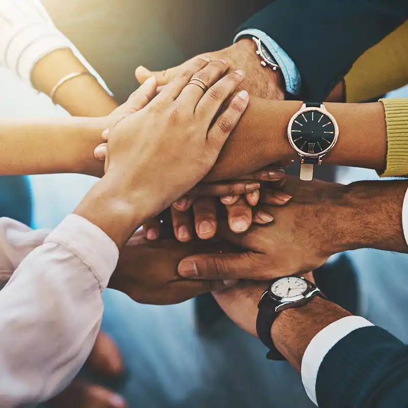 several people bringing their hands together