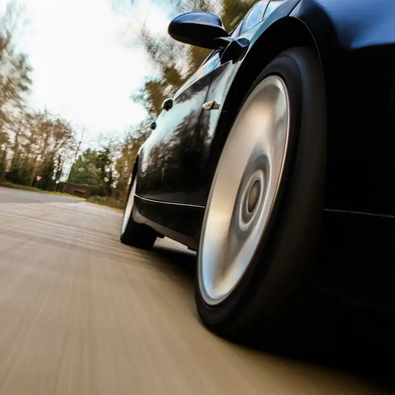 a car driving down a wooded road