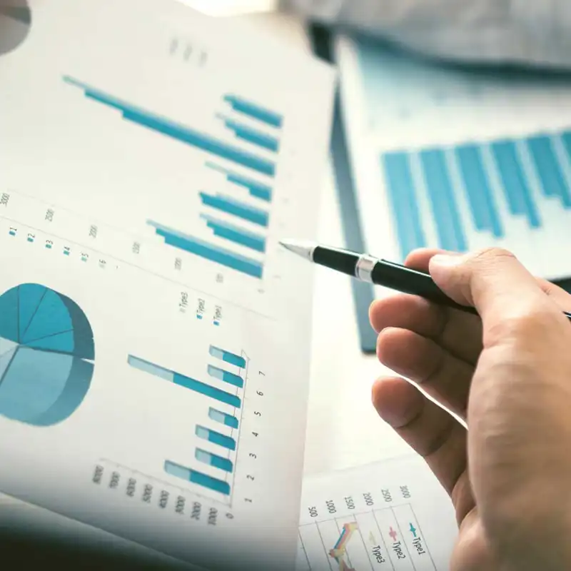 a hand pointing at several graphs