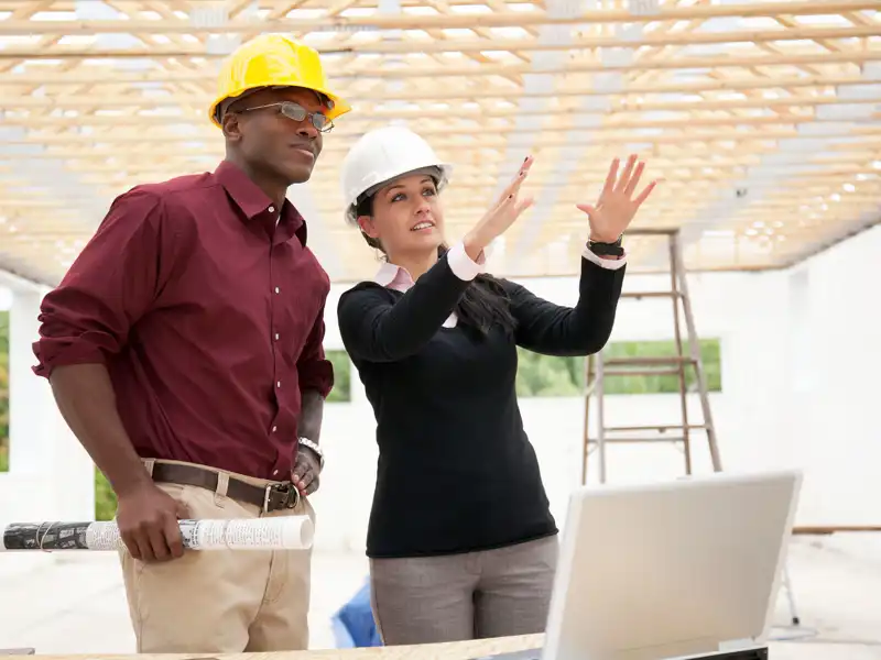 Two subcontractors discuss a construction project
