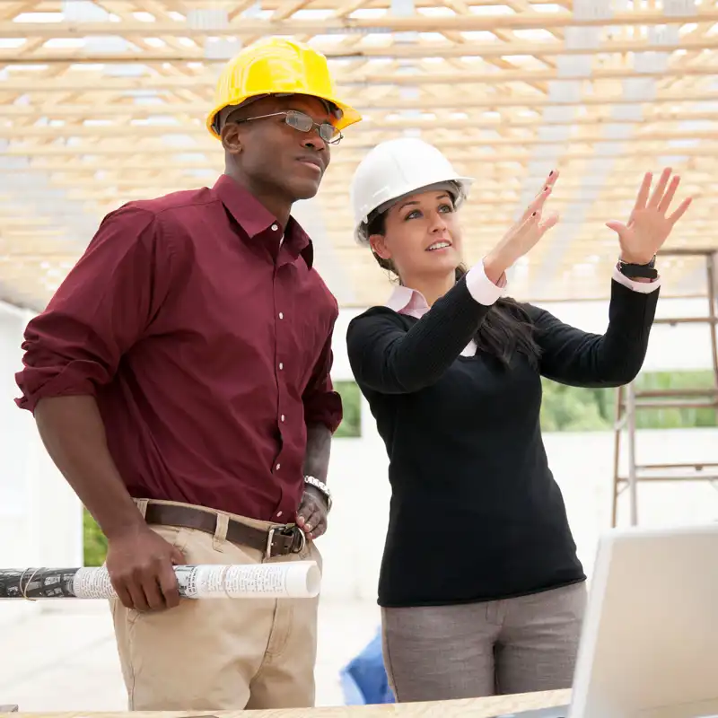 Two subcontractors discuss a construction project