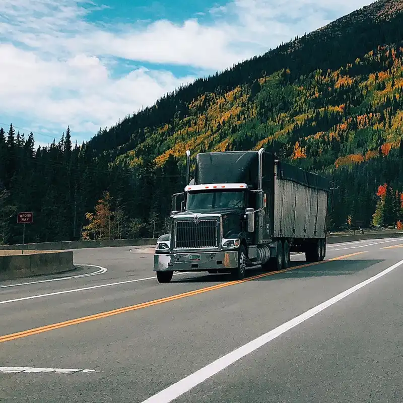 a semi truck going through the mountains